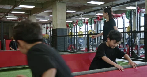 Active Chinese children having exercise class with their coach in gym,4K Stock Footage 156604536