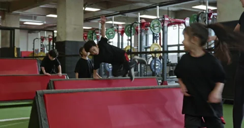 Active Chinese children having exercise class with their coach in gym,4K Stock Footage 156609552