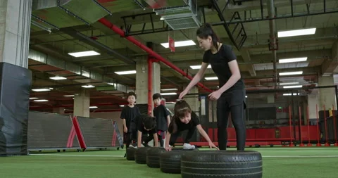Active Chinese children having exercise class with their coach in gym,4K Stock Footage 156627954
