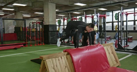 Active Chinese children having exercise class with their coach in gym,4K Stock Footage 156639277