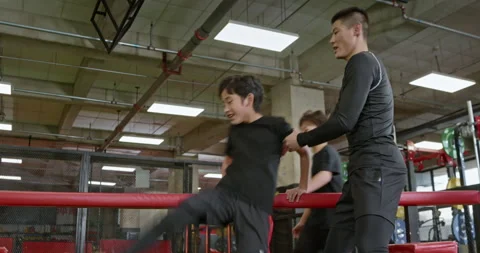 Active Chinese children having exercise class with their coach in gym,4K Video stock 156725305