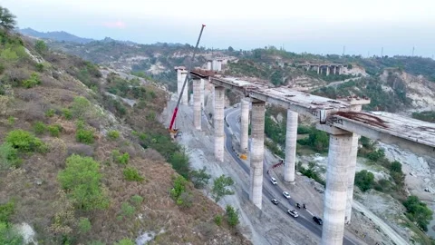 Active civil engineering: Crane lifting materials onto bridge pillars.  Stock Footage 335643690