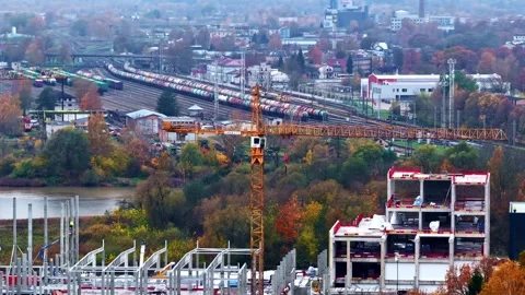 Active construction site with a large tower crane with Jelgava train station in Stock Footage 326034347