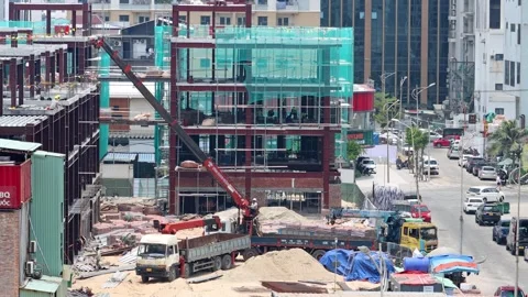 Active construction site with workers, cranes, and scaffolding Stock Footage 343230013