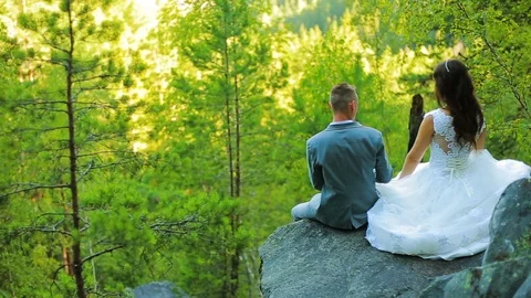 Active couple climbing on the rock in the forest with cliffs, pine trees Stock Footage 95837725