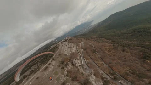 Active couple flying on paraglider over nature seascape with cloudy sky at Stock Footage 154737891