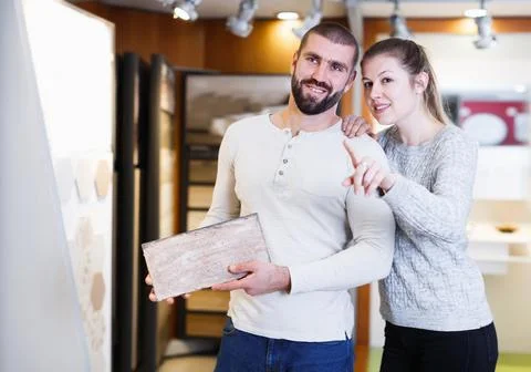Active couple looking sample of ceramic tile Stock Photos