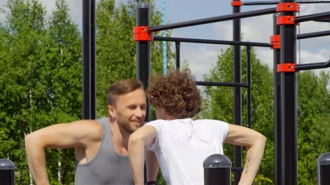 Active Couple Performing Dips on Parallel Bars Video stock 97639055