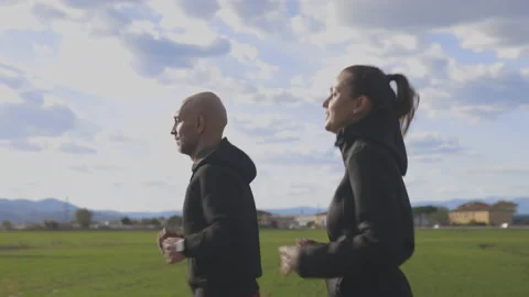 Active couple run during a sunny day in their leisure. Jogger concept outdoor Stock Footage 150465716
