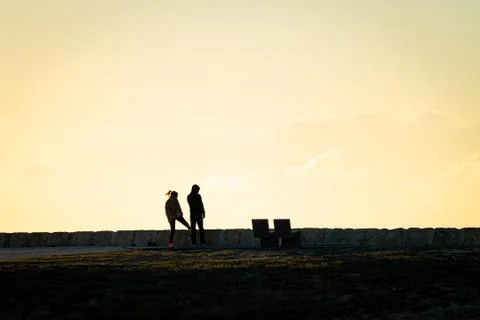 Active Couple Stretch Before Sunset Stock Photos