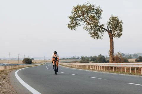 Active cyclist using bike for training on paved road Stock Photos