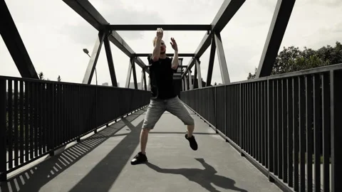Active dance in the city. A man in a black T-shirt dances an electro dance. Stock Footage 252069870