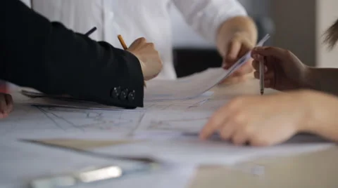 Active discussion of charts and plans on paper with your hands and pencils Video stock 64967575