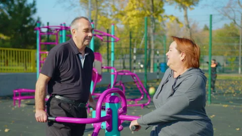 Active elderly couple doing sports on the simulator outdoors. Exercising Stock Footage 164247577