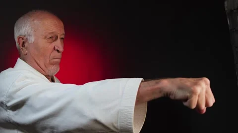An active elderly man athlete punches with his hands Video stock 341663628