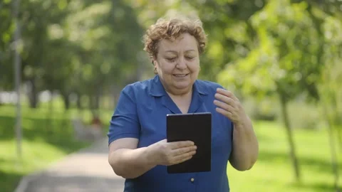 Active Elderly Woman Socializing with Tablet in Hand Stock Footage 287175135