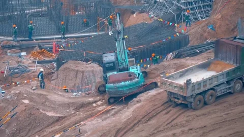 An active excavation and foundation construction site with heavy machinery Stock Footage 340626298
