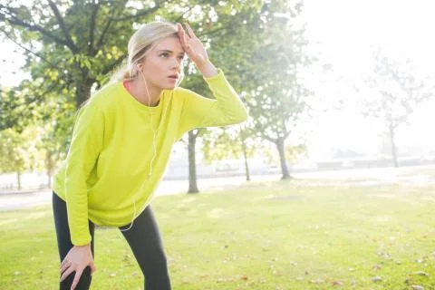 Active exhausted blonde pausing after running Stock Photos