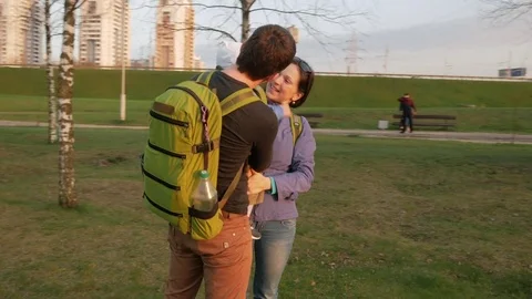 Active family with the baby walks in the park in the spring. Green grass and the Stock Footage 76088053