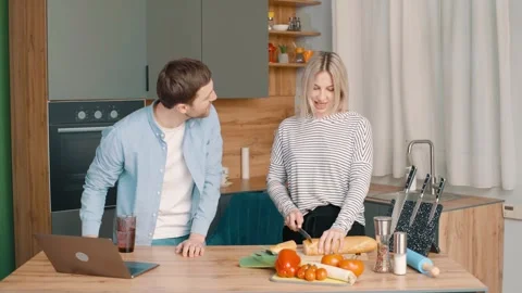 Active family singing and dancing laughing together preparing food at home Stock Footage 248523452