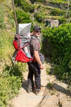 Active father with his child in backpack hiking. Stock Photos