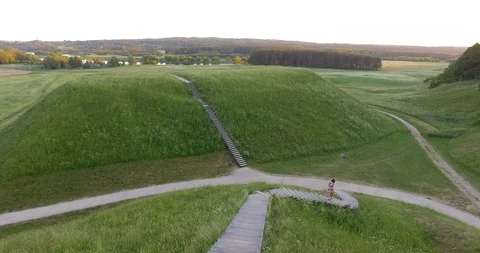 Active female model running down stairs on mound wooden stairs. Aerial drone Stock Footage 119689591
