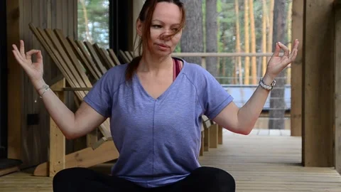 Active female  practicing meditation and yoga doing stretching exercise Stock Footage 301548167
