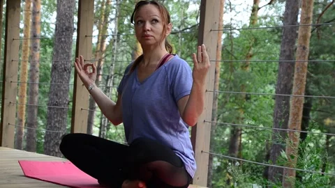 Active female  practicing meditation and yoga doing stretching exercise Stock Footage 301548170