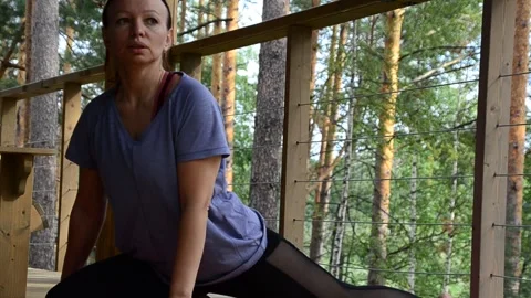 Active female  practicing meditation and yoga doing stretching exercise Stock Footage 301548581