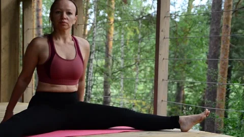 Active female  practicing meditation and yoga doing stretching exercise Stock Footage 301548624