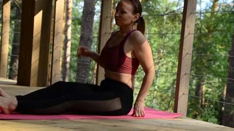 Active female  practicing meditation and yoga doing stretching exercise Stock Footage 301548655