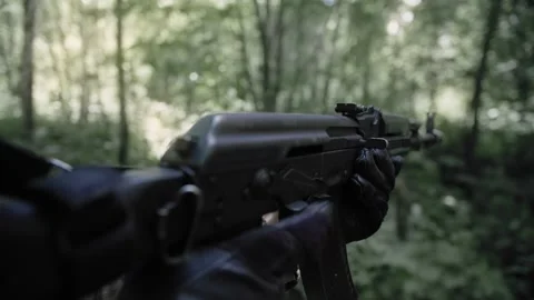 Active fighting in a dense forest, an armed soldier with a machine gun Stock Footage 327447516
