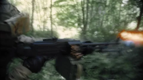 Active fighting in a dense forest, an armed soldier with a machine gun Stock Footage 327447530