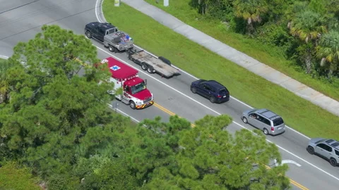 Active fire rescue vehicle moving along Florida roadway, emergency signals Stock Footage 311010933