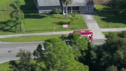 Active fire rescue vehicle moving along Florida roadway, emergency signals Stock Footage 325403875