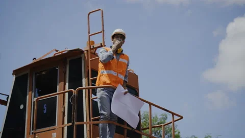 Active Foreman in Building Construction Inspection Use blue print to manage work Stock Footage 159277237