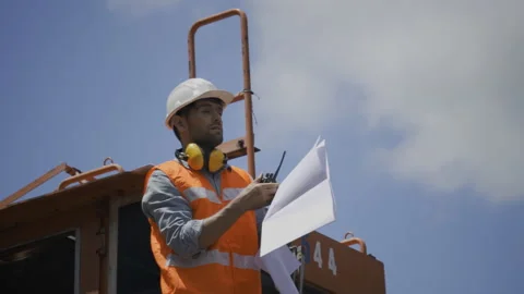 Active Foreman in Building Construction Inspection Use blue print to manage work Stock Footage 159277882