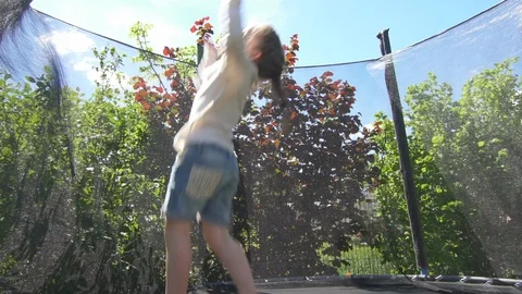 Active girl doing tricks jumping on trampoline. Handheld shot Video stock 109592411