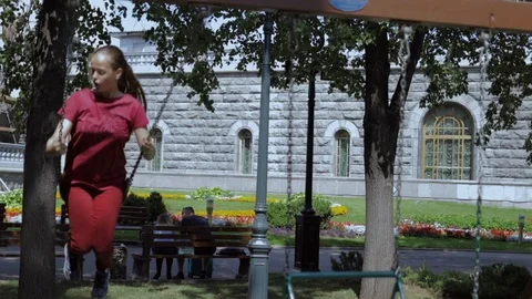 Active girl having fun on swing outdoors. Stock Footage 114489896