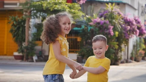 Active girl or sister nanny and cute little baby boy jumping dancing on the Stock Footage 127297937