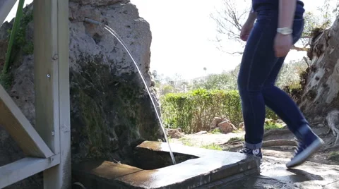 Active girl washes hands under the faucet in natural water Stock Footage 62735975