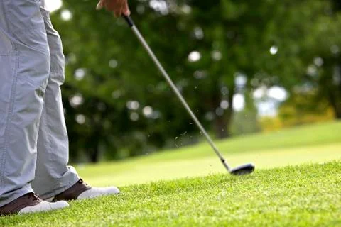 Active golfer pitching. Stock Photos