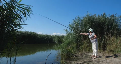 Active happy and healthy elderly European woman  fishing 스톡 동영상 141646764