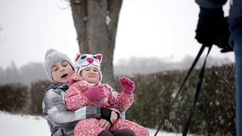 Active Happy Children Sledding and Enjoying Winter Snowy Day in Slow Motion Video stock 71272395