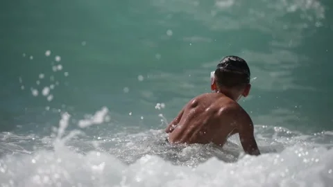 Active healthy kid in diving mask playing in blue sea with high waves during Stock Footage 158910863