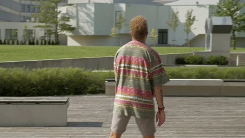 Active hipster doing soccer tricks with a ball outdoors. Stock Footage 132561742