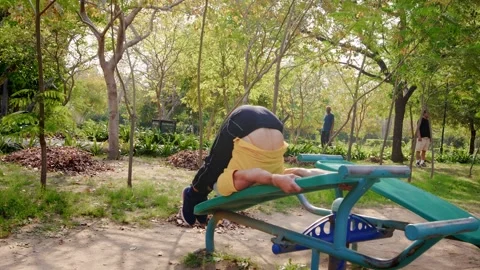 Active Indian Male Elderly Doing workout on Outdoor Gym equipment in Green park. Stock Footage 249941436