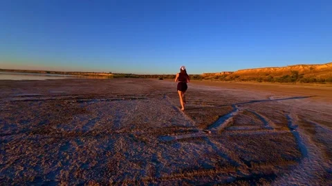 Active Jogger Sprinting Across Open Salt Flat During Golden Hour Stock-Footage 344818118
