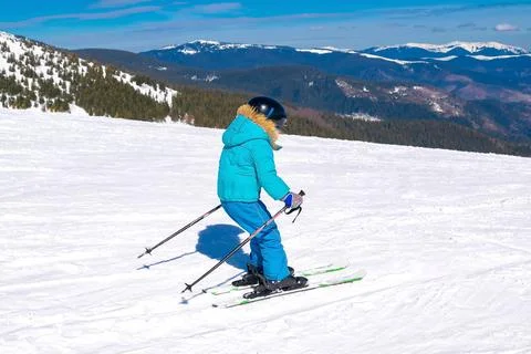 Active kid boy riding downhill,learn skiing in mountains alpine winter resort Stock Photos