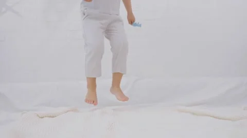 Active kid jumping on the bed Stock Footage 246838841